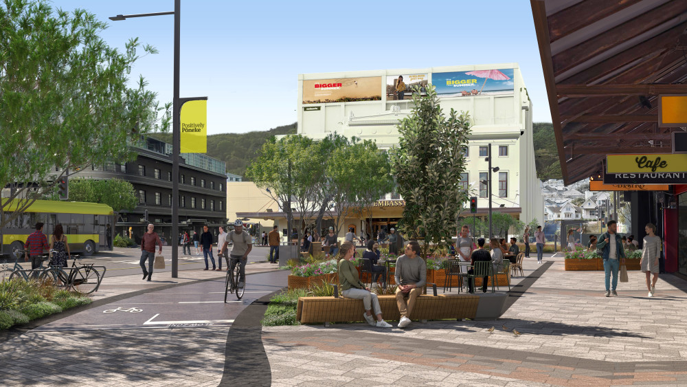 Image shows Courtenay place once construction is complete. The image is looking towards the Embassy Theatre, from the southern side of the street. It shows a cycle path on the left, outdoor dining areas in the middle and a wide area for walking on the right. 
