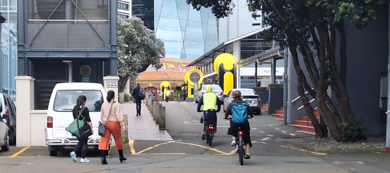 Decorative image showing people walking and cycling down the TSB Arena Service lane